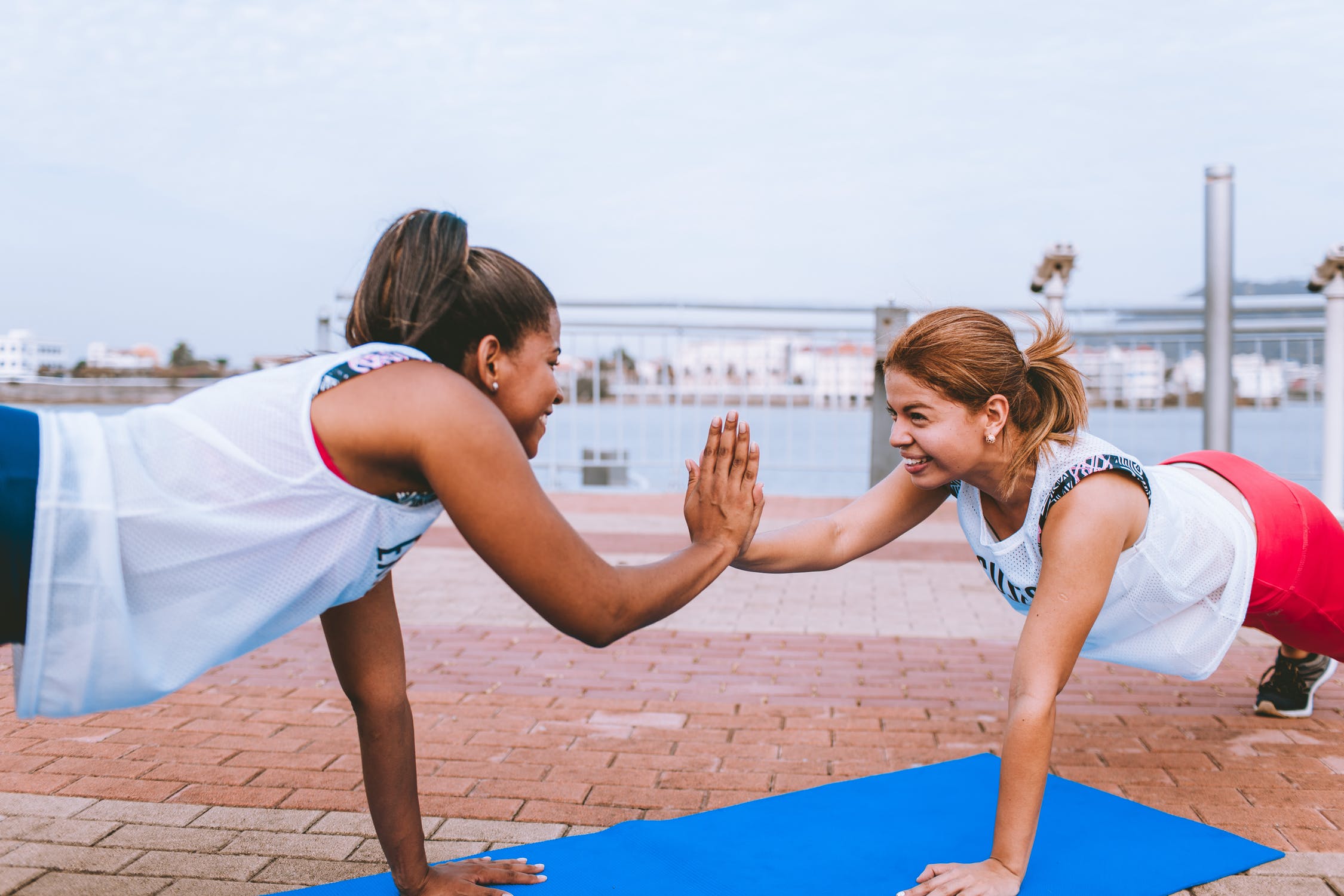 two women performing plank exercise