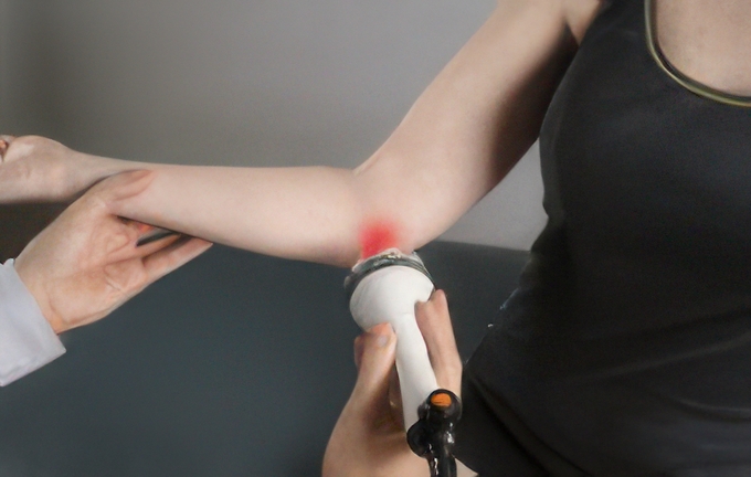 Deep tissue laser therapy being used to treat elbow pain and soft tissue injury