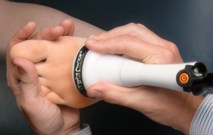 Deep tissue laser therapy being applied to a patient’s foot using a handheld device