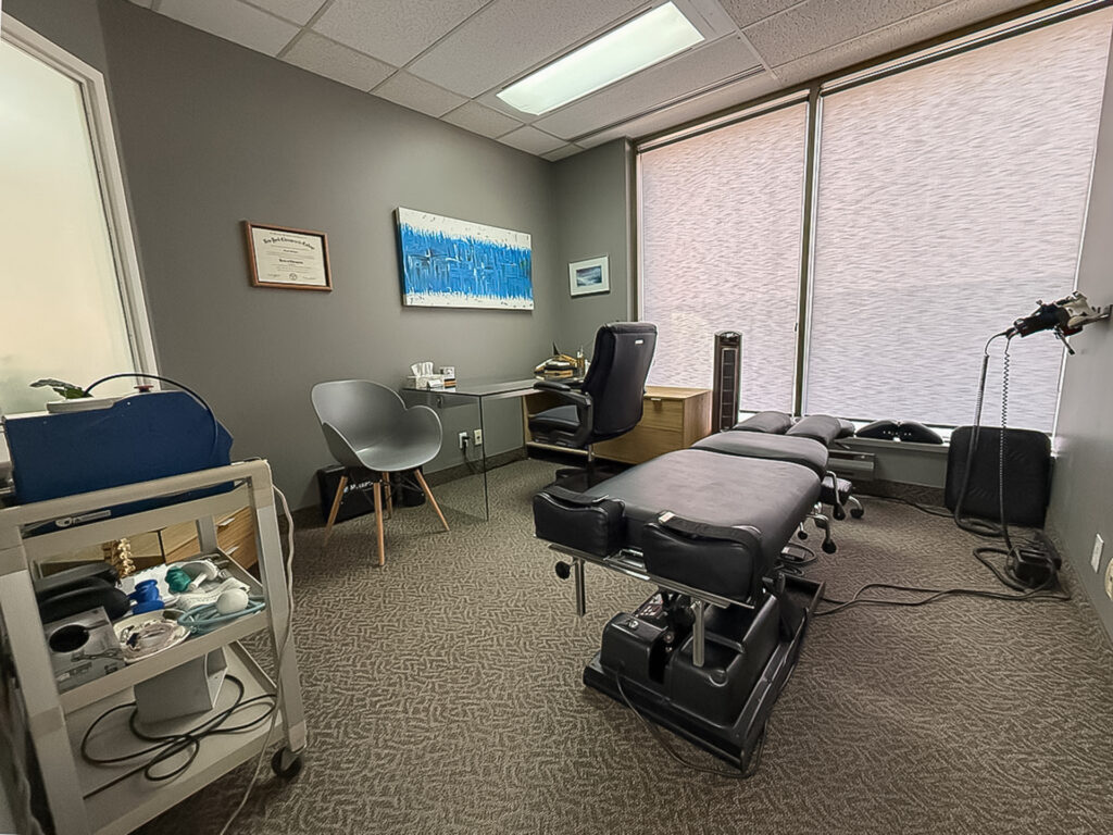 Treatment room at Inline Health & Sports Injury Clinic in Ottawa with chiropractic table and equipment